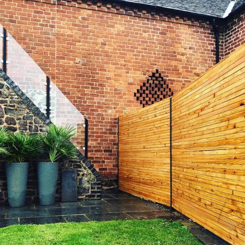 DuraPost Anthracite Grey Classic posts installed with timber fence panels
